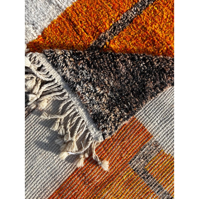 This Moroccan Mrirt Beni Ouarain rug is a handwoven piece produced by skilled artisans from the Middle Atlas region of...