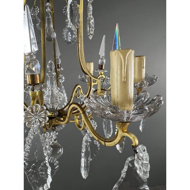 Brass and Crystal Chandelier Give your home an exceptional touch with this magnificent gilded brass chandelier, adorned...