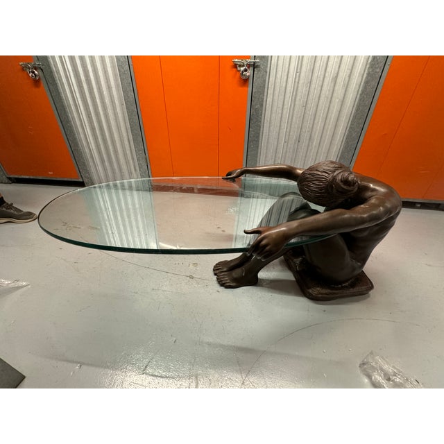 This striking life-sized female bronze sculptural coffee table seamlessly blends art and function. Crafted with precision,...