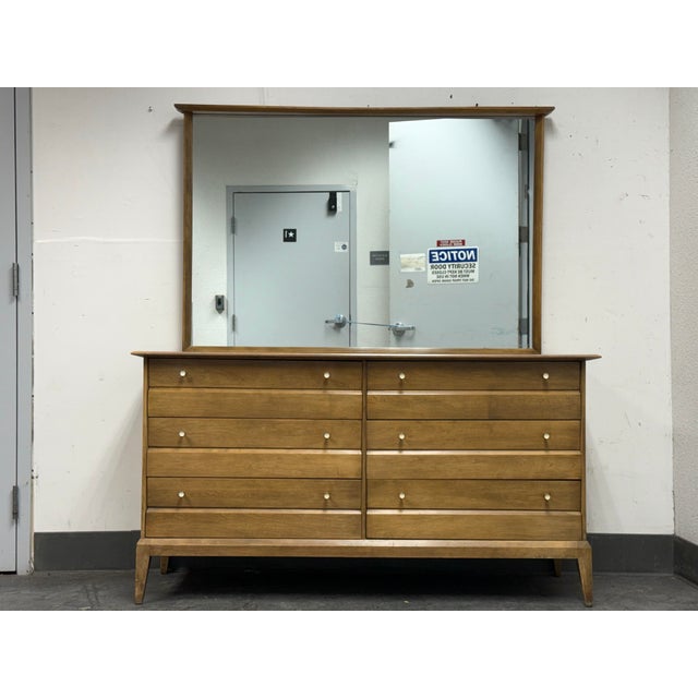 Design Plus Gallery presents a Cadence Dresser + Mirror from Heywood Wakefield. This mid-century inspired set pairs a...