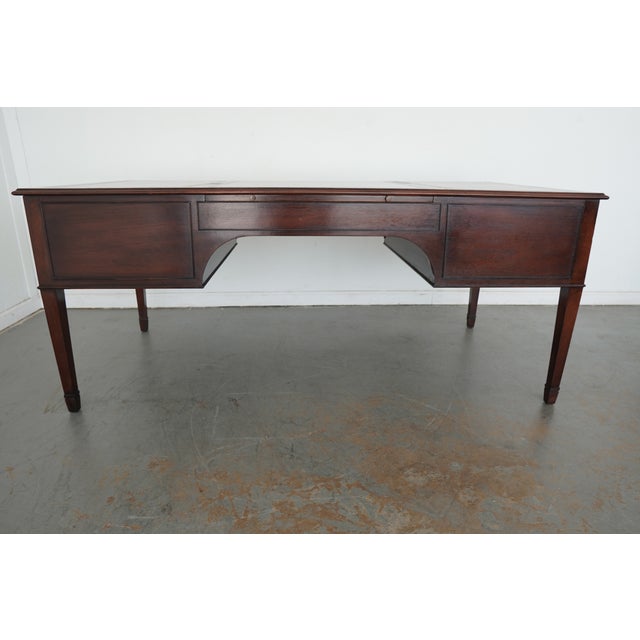 This vintage writing desk from the late 20th century is a beautifully classic piece with a rich wood finish, traditional...