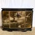 This Chinese black lacquered credenza showcases exquisite hand-painted floral detailing across its gracefully curved...
