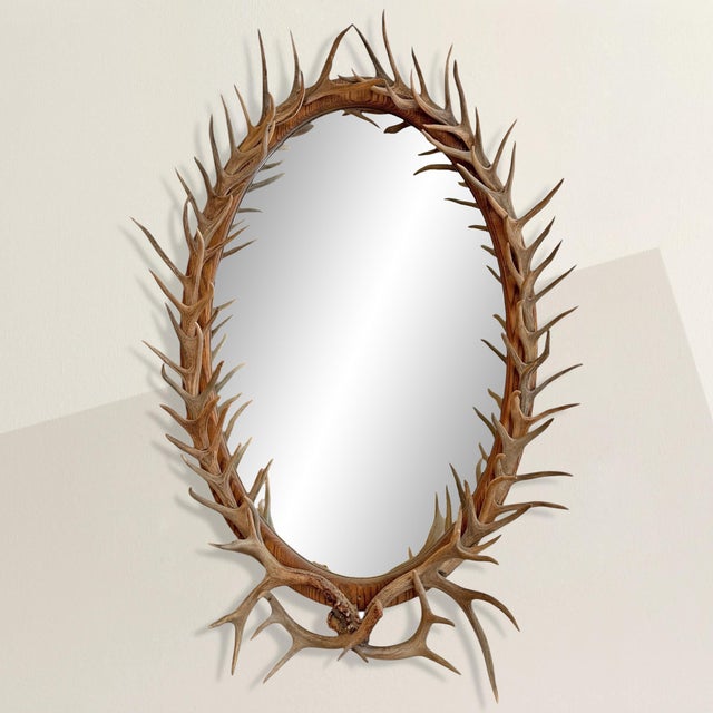 This oval mirror doesn’t just borrow from the language of the wilderness, it speaks it fluently. Its oak frame is entirely...