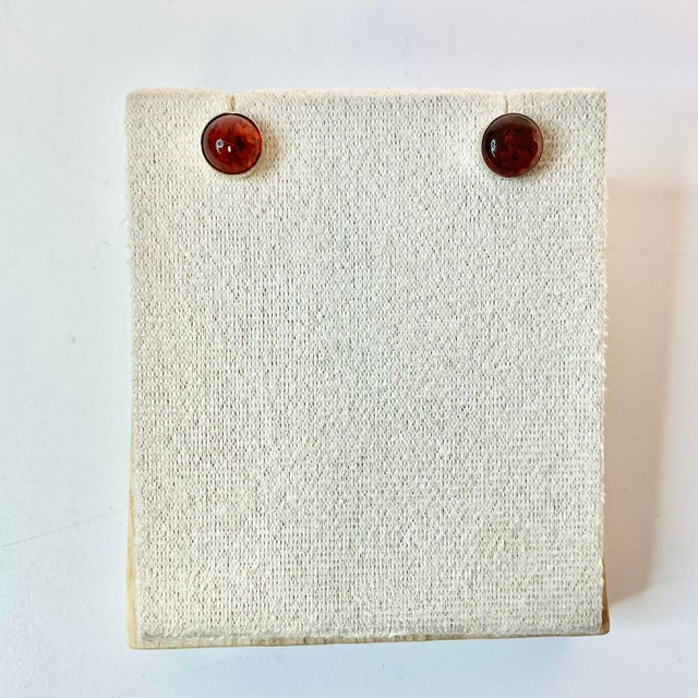 A lovely pair of Italian Sterling and Amber Button Stud Earrings from the 1970s. They feature a round piece of Amber in...