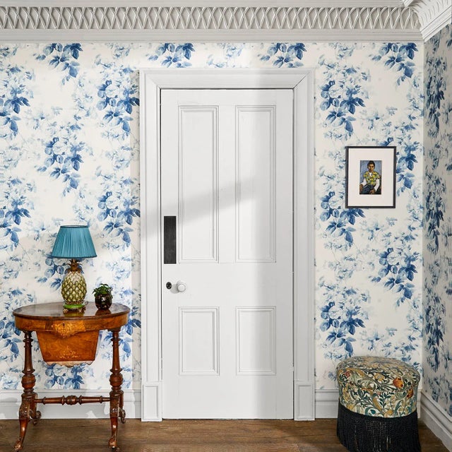 The 'London Rose' wallpaper features a classical hand-painted English rose design in China against an off-white base. This...
