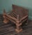 A wrought and cast-iron fire basket with obelisk finials set on sturdy square column and plinth legs. Swan’s nest fire...