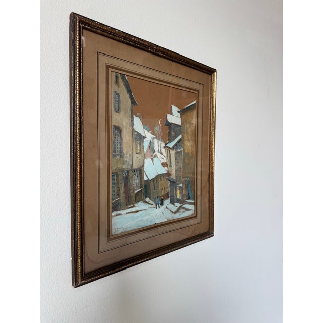 This evocative 1922 winter cityscape by G. Belnet captures a quiet, snow-covered street lined with tall, historic...