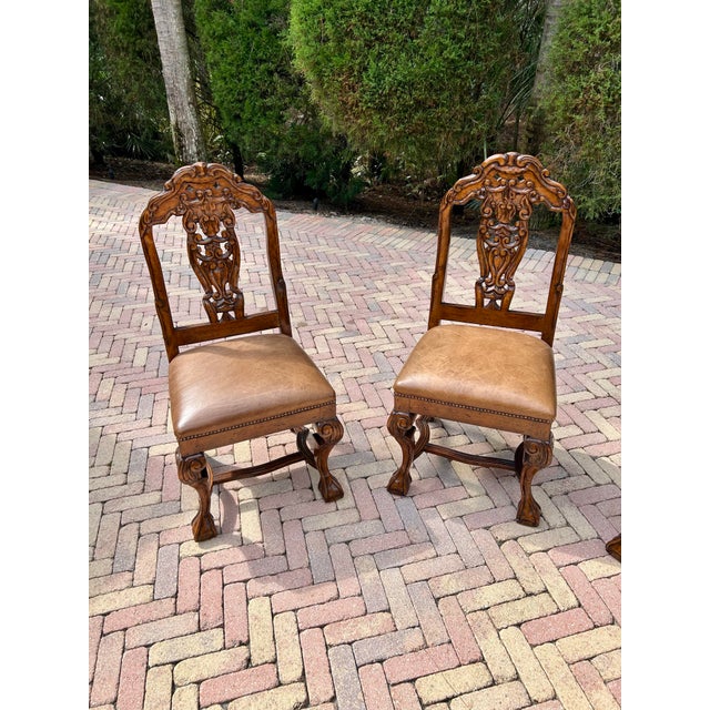 A refined set of four Dutch Chippendale–style dining chairs, beautifully crafted with a warm fruitwood finish. These...