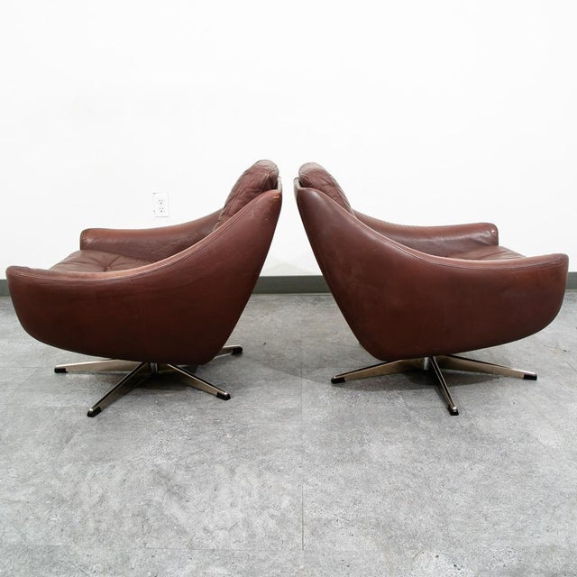 Pair of brown leather swivel chairs by unknown Danish designer. Original soft leather in brown set on a swivelling metal...