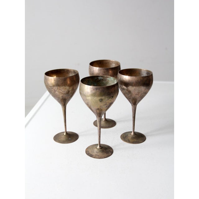 A mid-20th-century set of four Leonard silverplate goblets that bring a refined sense of history to any bar or tabletop...