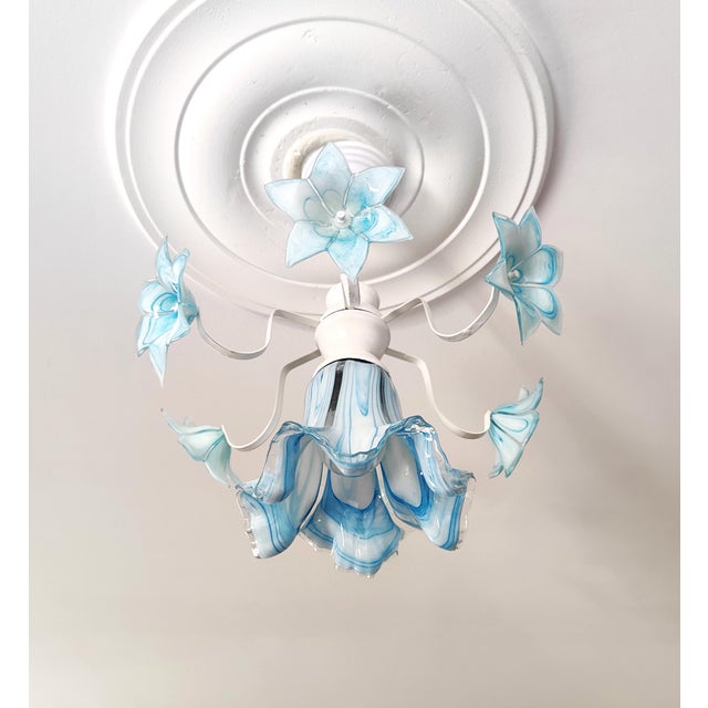 Rare 1980s vintage Murano glass chandelier in stunning blue with white metal frame. This small Italian floral ceiling...