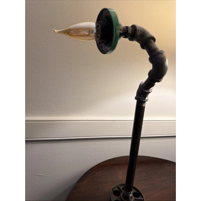 Industrial lamp made out of iron pipe and other similar parts in good working order. It would be perfect for someone who...