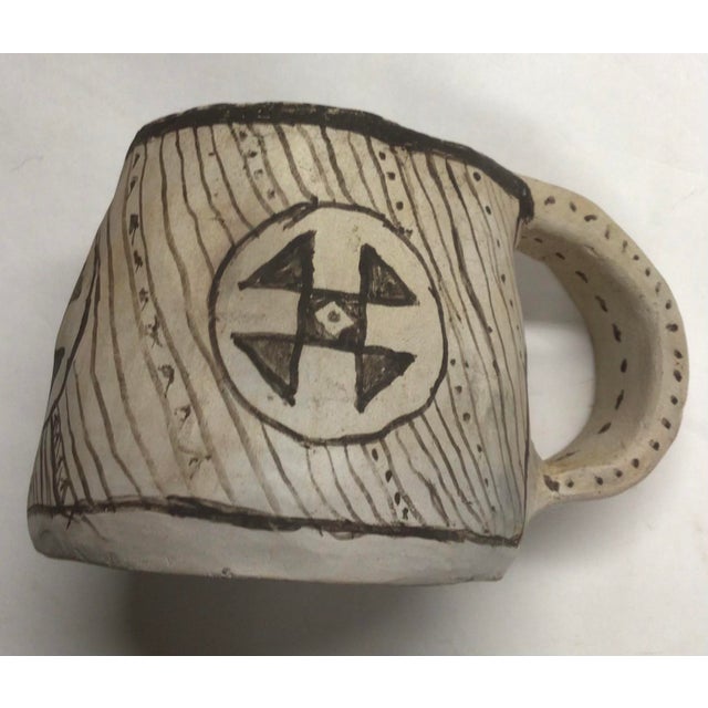 Wonderful primitive style handmade ceramic mug with ink-like calligraphic markings on sides and handle.