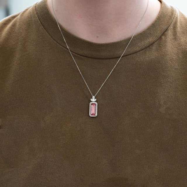 A vivid 4.4Ct pink tourmaline takes center stage, illuminated by delicate earth-mined diamond accents in solid 14K gold....