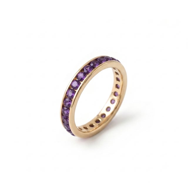 Add a touch of regal elegance to your jewelry collection with this stunning full eternity band, designed to showcase a...