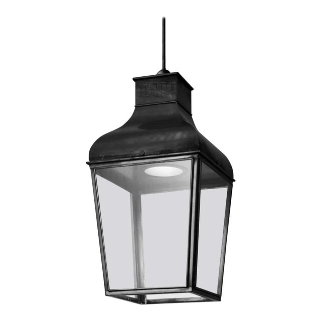 Hanging light in dark bronze with pagoda structure, closed top, outside fitted clear glass. For indoor and outdoor use...