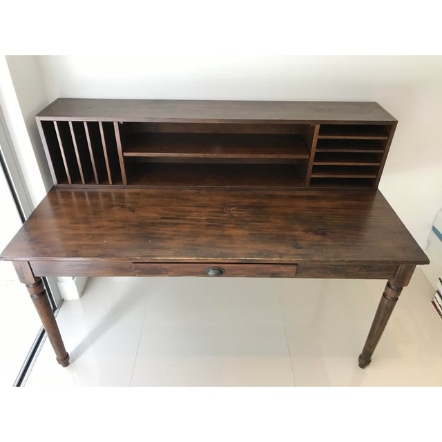 Tuscan Chestnut finished pieces are built from solid pine and pine veneer; hardware has an antique brass finish. The use...