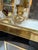 Elegant vintage picture frame featuring a polished brass border with a contrasting black glass surround. Its bold...