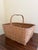A beautifully woven early 20th century American splint oak basket with warm honeyed tones and a tightly constructed...