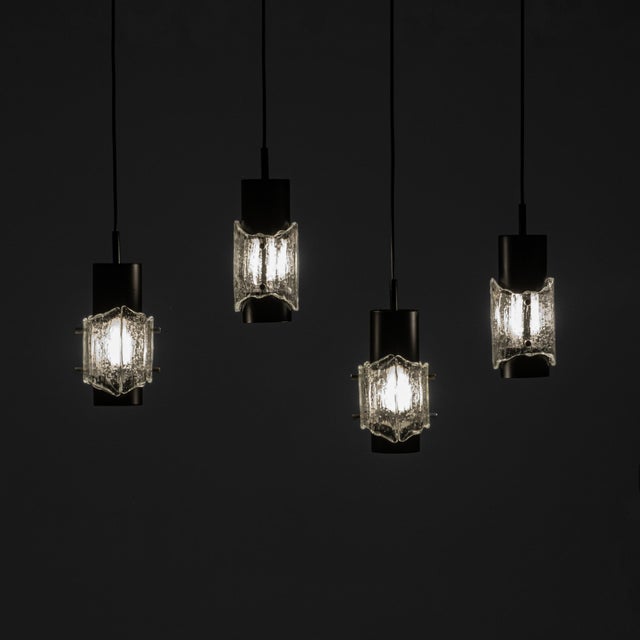 This set of four pendant lights exemplifies the refined material palette and restrained elegance associated with...