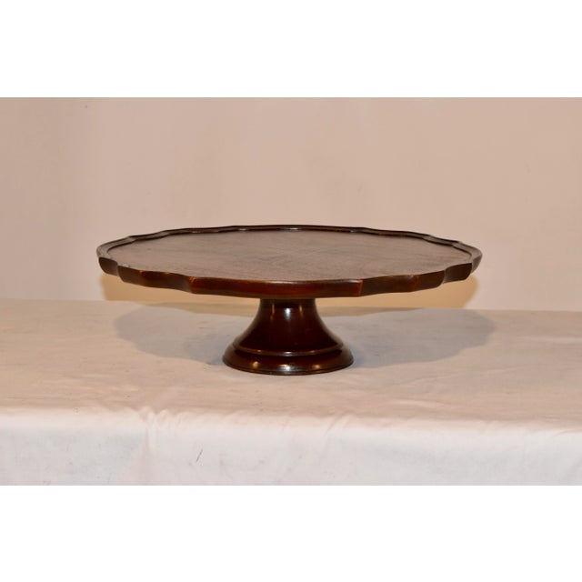19th century mahogany lazy Susan from England with a molded and scalloped edge around the top, which has wonderful...