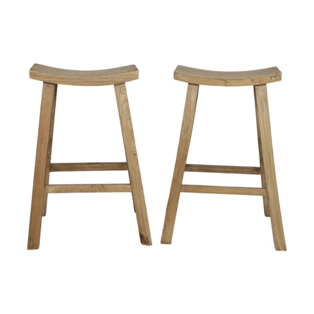 A pair of traditional saddle bar stools made of solid poplar. Beautiful grain decorates the plank wood tops, and straight...