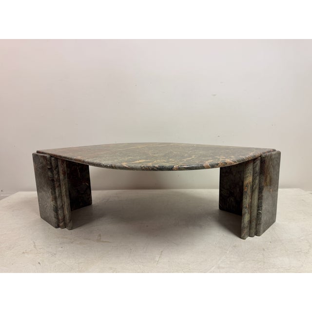 A sculptural Italian marble coffee table from the 1980s, formed in a striking biomorphic silhouette with softly curved...