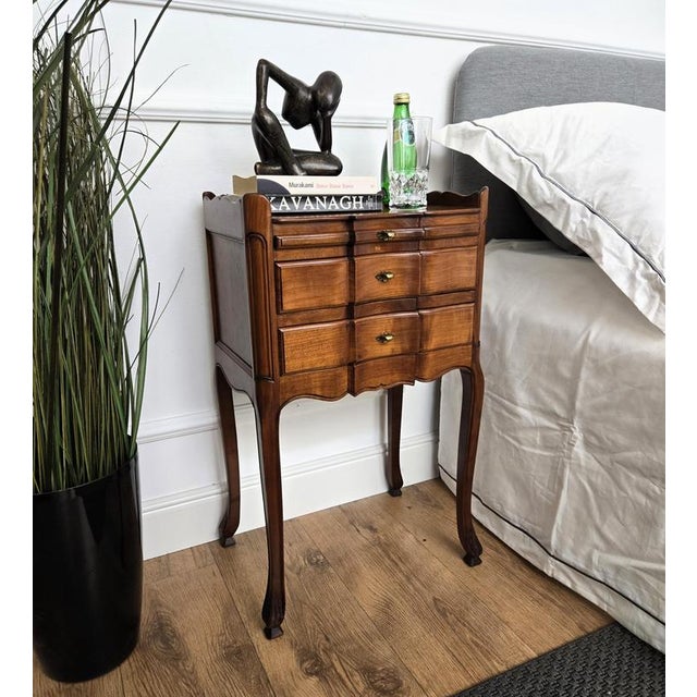 A French pair of bedside tables night stands with two drawers and sliding tray. The top parts are surrounded by a three-...