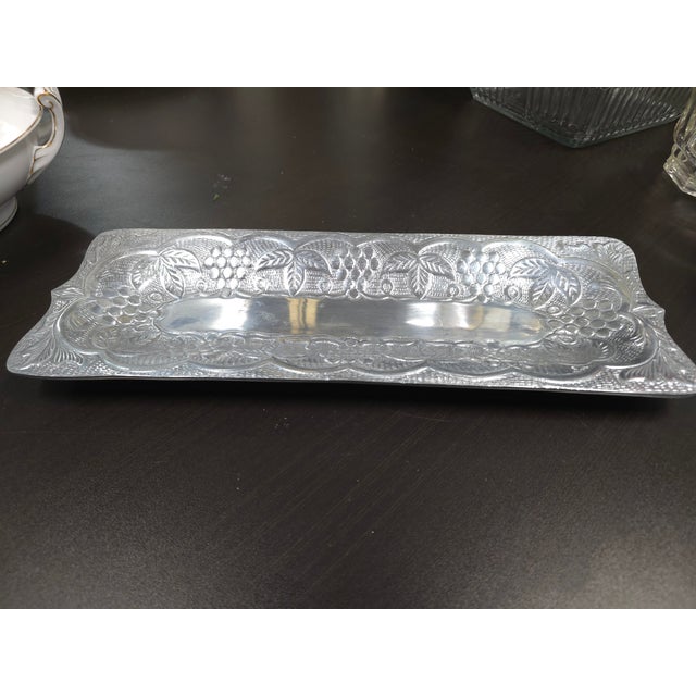 Beautiful aluminum tray featuring a grape and vine motif. Label on the back is faded but reads 'made in India.'