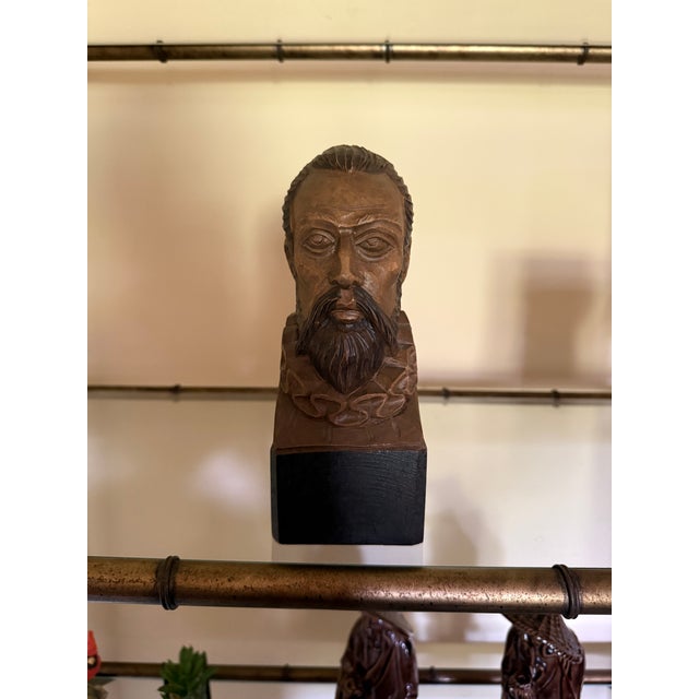 A finely hand-carved wooden bust depicting the legendary Spanish literary hero Don Quixote, produced by OURO Artesanía of...