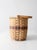 This vintage mid-century woven splint basket has a tall oval shape accented with soft blue and red bands and a graceful...