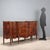 Walnut and crotchet sideboard with maple, ebony, and rosewood trim. The curved, split front features a projecting central...