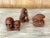 Set of three Japanese netsukes carved out of wood with a reddish stained finish, appear to be circa mid-20th century. One...