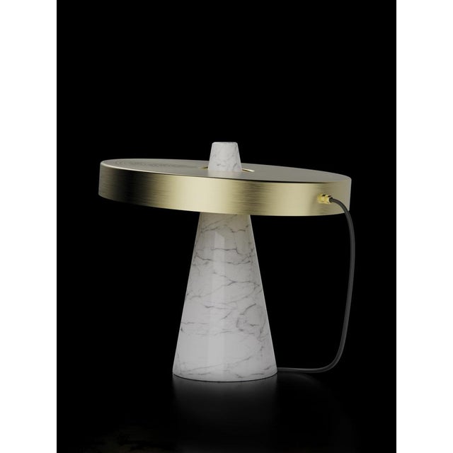 Table lamp with Carrara white stone base and brushed brass lightshade. The light shade is disconnected from the stone base...