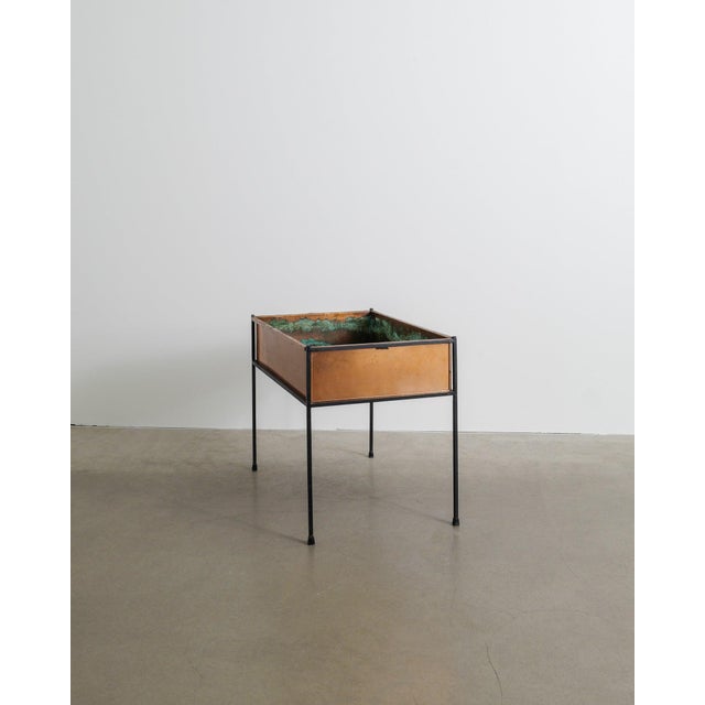 A rare and decorative rectangular swedish mid century planter / flower table in patinated copper and a black lacquered...