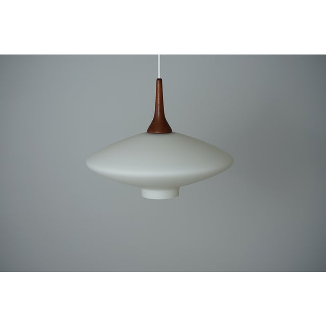 Manufacturer: Unknown, Denmark Designer: Unknown Model: "UFO" Material: Opal glass and teak Age: 1960s Height: 27 cm...