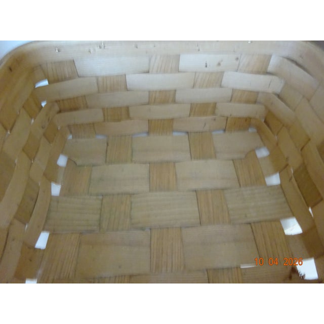 Vintage light brown picnic basket with 2 handles of carrying. The top is secured by 2 metal backets allowing the lid to...