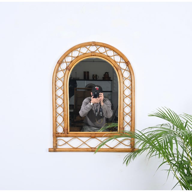 Marvellous Côte d'Azur style arch-shaped wall mirror in bamboo and rattan and wicker. This fantastic item was produced in...