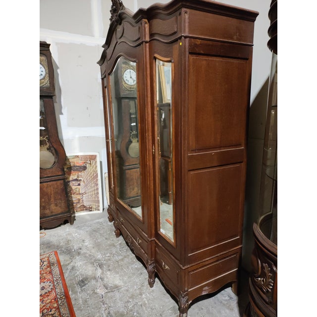 Impressive late 19th–early 20th century French Louis XV Revival triple-door armoire, crafted in solid walnut and featuring...