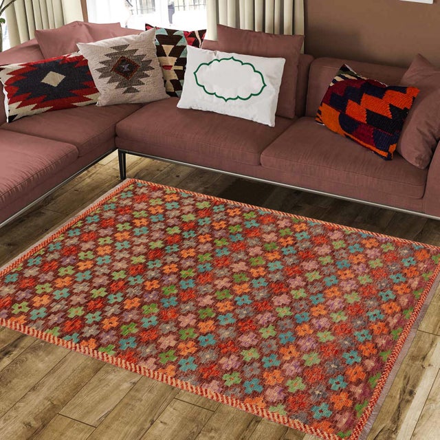 This stunning hand-knotted Afghan Balouchi rug is a captivating addition to any decor. Crafted by skilled artisans, it...