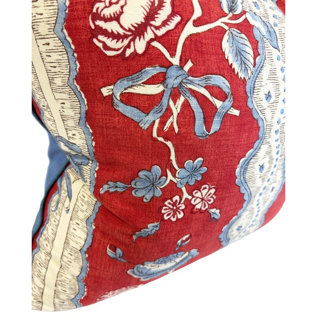 Decorative pillow in red, blue and white French style linen block print fabric front and solid blue back and welt trim.