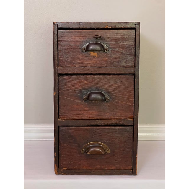 Handcrafted Arts and Crafts period industrial style oak bank of drawers with half-moon pulls, circa 1910. Likely an...