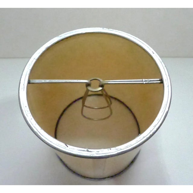 Handmade of ecru parchment with silver rims and candelabra clip.