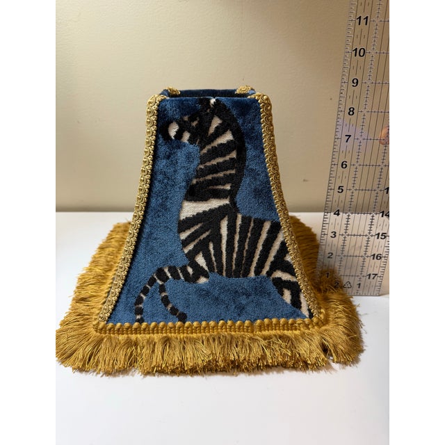 A striking, custom-made lamp shade crafted in luxurious Regal Farlow velvet in a rich sapphire blue zebra pattern,...