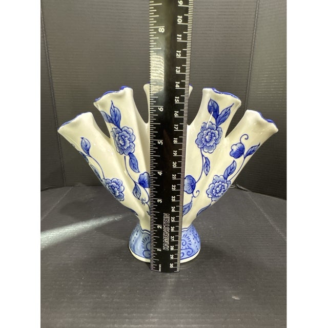 Add a touch of timeless charm to your décor with this **Vintage Bella Casa by Ganz Blue & White Ceramic Floral Tulip Fan...