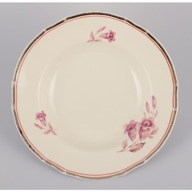 Arabia, Finland. A set of seven deep ‘Myrna’ faience plates. Floral motif in autumn colours. Marked. Approximately 1940s....