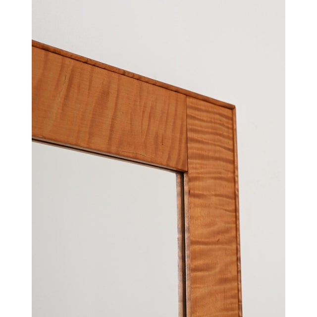 Rectangular mirror with a marbled birch frame and a frame construction. 1950s, Scandinavia. A 1950s Scandinavian mirror...