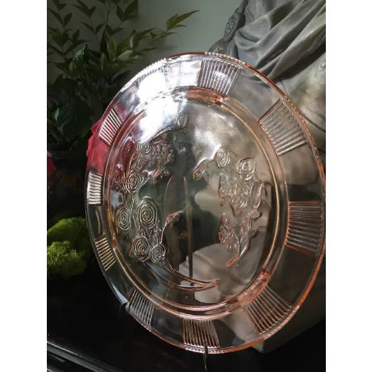 Beautiful pink depression glass cake stand with roses pattern. Perfect addition to any tablescape and for the interior...