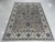 This gray wool rug features a hand knotted pile construction in the traditional Sarouk style. Crafted in India, the rug...