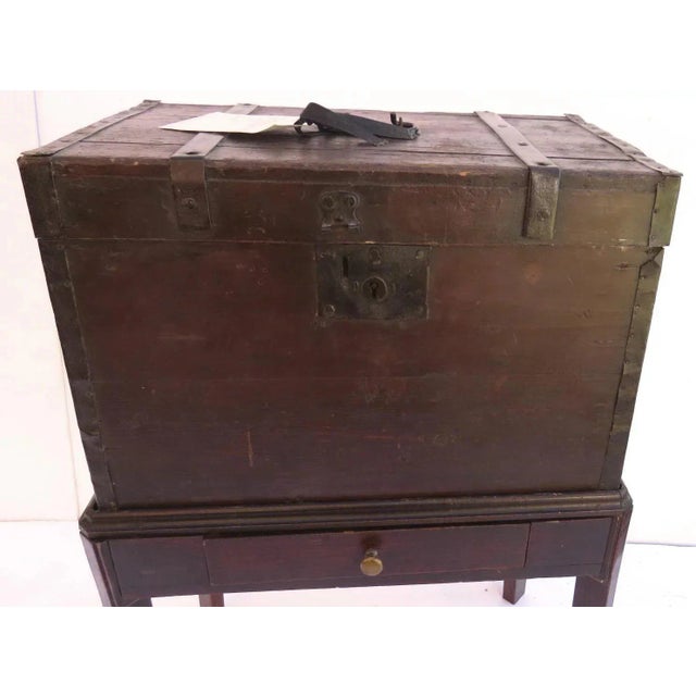 Immigrant’s trunk on custom stand. Reads: "D. J. Stokes" for voyage across the ocean to America. Old red paint, iron...